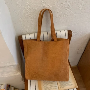 Close-up of caramel corduroy tote bag featuring soft texture and long shoulder straps