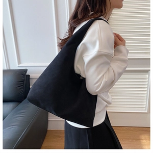 Minimalist black faux suede large tote bag styled on model for a retro casual look