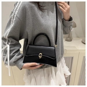 Fashionable black faux leather small square bag with golden interlocking metal buckle strap