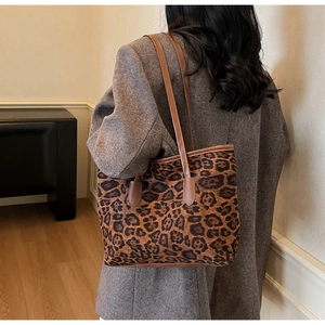 Detail view of large leopard print tote bag with brown straps for autumn fashion