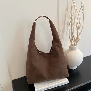 Retro brown suede tote bag featuring a spacious interior and minimalist wide shoulder strap