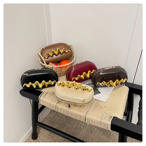 Detailed close-up of oval leather clutches in five colors with golden wave metal accents