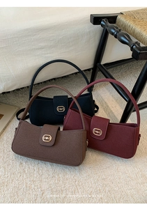 Three baguette bags in black, brown, and burgundy featuring gold horsebit hardware details