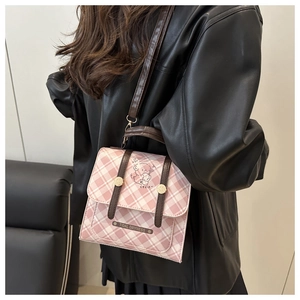 Pink checkered crossbody bag with cute bear illustration and brown handle detail