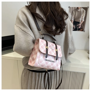 Sac bandoulière à carreaux rose et blanc avec imprimés cartoon, porté sur le dos du modèle