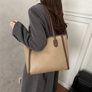 Minimalist khaki patchwork tote bag with dark brown straps shown on a model