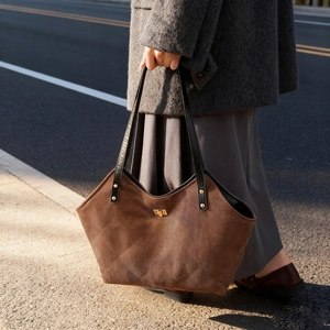 Brown faux suede tote bag with quilted diamond pattern and golden twist lock closure