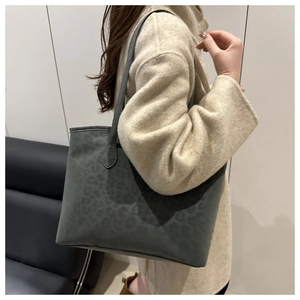 Fashionable dark grey leopard print tote bag shown on shoulder for a stylish look