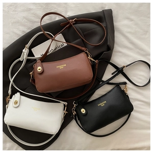 Close-up of litchi-textured PU leather handbags with golden twist locks and logo