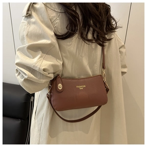 Brown litchi grain leather crossbody bag with golden Fashion Bag lettering detail