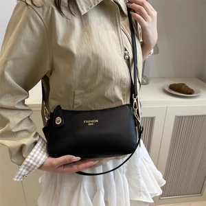 Chic black litchi pattern underarm bag with gold hardware and shoulder strap