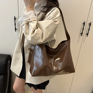 Brown patent leather tote bag with large capacity and adjustable metal eyelet straps