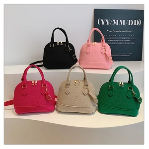 Collection of shell-shaped faux crocodile leather handbags in five vibrant colors with gold hardware