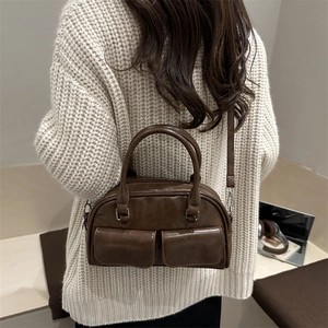 Brown vintage Boston bowling bag with dual front pockets and adjustable shoulder strap