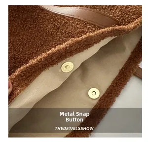 Close-up of the magnetic snap closure and beige lining on the brown plush tote bag