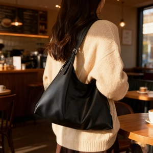 Minimalist black leather tote bag for women with adjustable strap in casual daily style