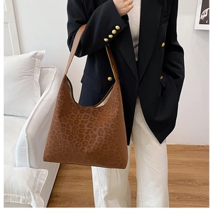 Brown leopard print tote bag styled with a black blazer for a casual chic commuter look