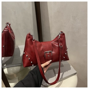 Close-up of red Y2K rivet tote bag featuring silver studs and metallic buckle detail