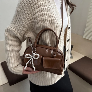 Brown gloss PU shoulder bag with pearl bow charm and dual front pockets for women