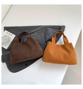 Close-up of minimalist suede tote bags in dark brown and yellow for daily use