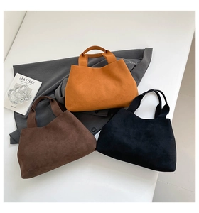 Detailed trio of minimalist bucket bags in caramel, brown, and black suede leather