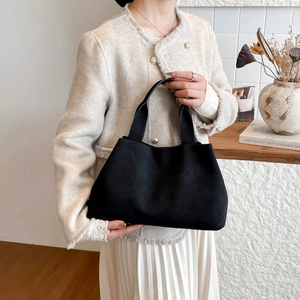 Minimalist black trapezoid tote bag in suede texture, perfect for stylish daily commute