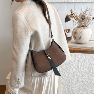 French retro hobo bag in brown suede with black leather trim and golden metal clasp