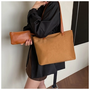 Detail of caramel suede tote bag set including matching small zippered pouch for women
