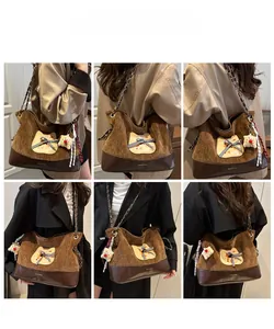 Vue macro du sac fourre-tout en velours côtelé marron avec écusson chat et chaîne