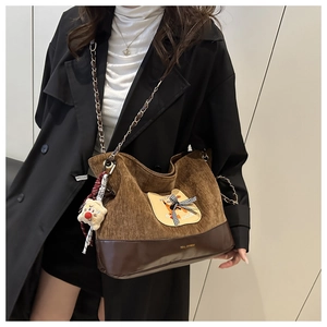 Détail du sac cabas vintage en velours côtelé marron avec broderie chat et chaîne en métal