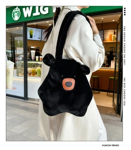 Detail of cute black plush bear shoulder bag with 3D ears and brown leather nose