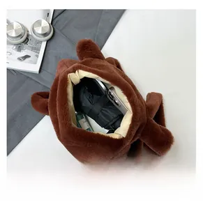 Spacious interior of brown plush capybara bag showing storage for phone and accessories