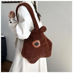 Brown plush bear tote bag with soft faux fur texture shown in a casual outfit context