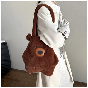 Detail of soft brown plush tote bag in capybara shape styled with a long beige coat
