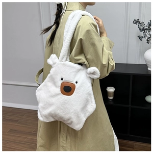 Detailed view of the soft white plush bear shoulder bag worn with a stylish beige coat