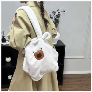 Detail of soft white plush bear shoulder bag with high-capacity tote design for winter