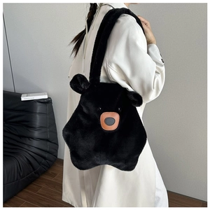 Detail of plush black bear shoulder bag with fuzzy ears and soft faux fur texture