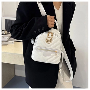 Close-up of white quilted mini backpack featuring gold M logo and trendy V-shaped stitching