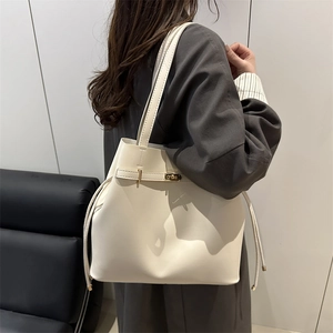 Ivory minimalist leather bucket bag with gold clasp and drawstring for women's daily commute