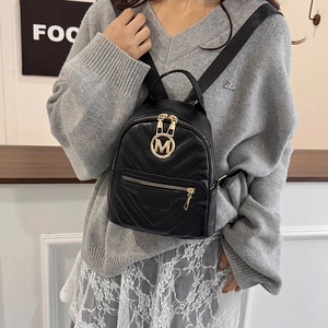 Women's black V-quilted mini backpack with gold M logo and versatile shoulder straps
