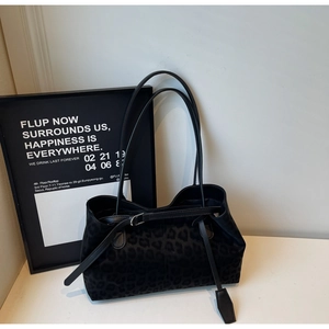 Detailed view of black leopard print tote bag in premium faux suede with slim straps