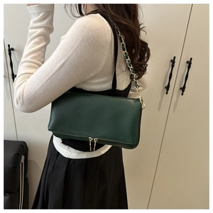 Dark green lychee texture leather shoulder bag with gold chain strap on model