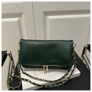 Detail of dark green pebble leather shoulder bag with gold zipper and chain strap