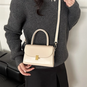 Retro cream crossbody bag with gold metal clasp and top handle for women's fashion