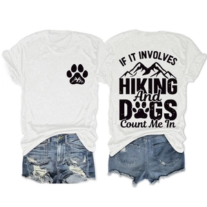 Close-up of white crew neck tee with hiking graphics and distressed denim shorts