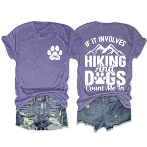 Detail view showing front logo and back hiking slogan on purple t-shirt with denim shorts