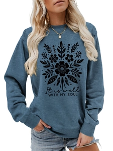 Detalle de sudadera azul marino con estampado floral negro y frase inspiradora