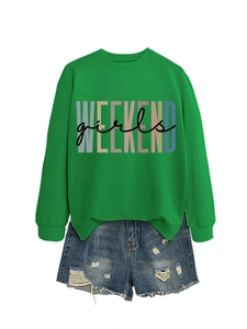 Flat lay of bright green crewneck sweatshirt with Weekend Girls print and denim shorts
