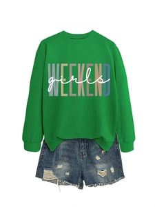 Flat lay of a green Weekend Girls sweatshirt paired with distressed denim shorts