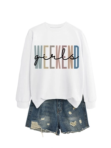 Flat lay of a white crewneck sweatshirt with girls WEEKEND print and ripped denim shorts